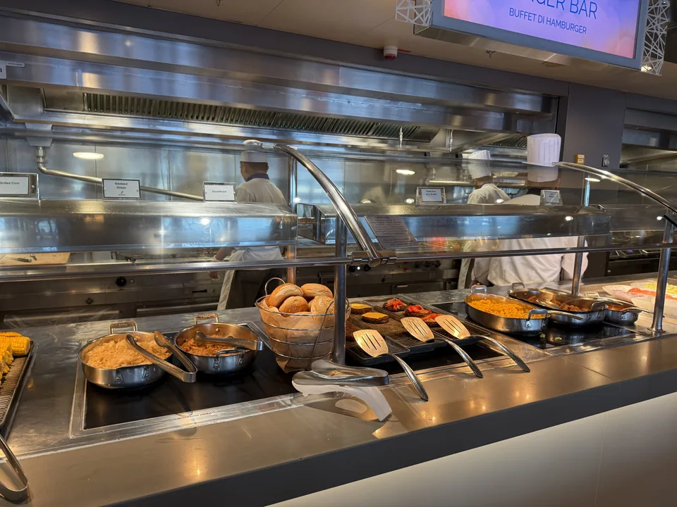Burgerstationen på Garden Café-buffeten med boller, bøffer og tilbehør på Norwegian Escape