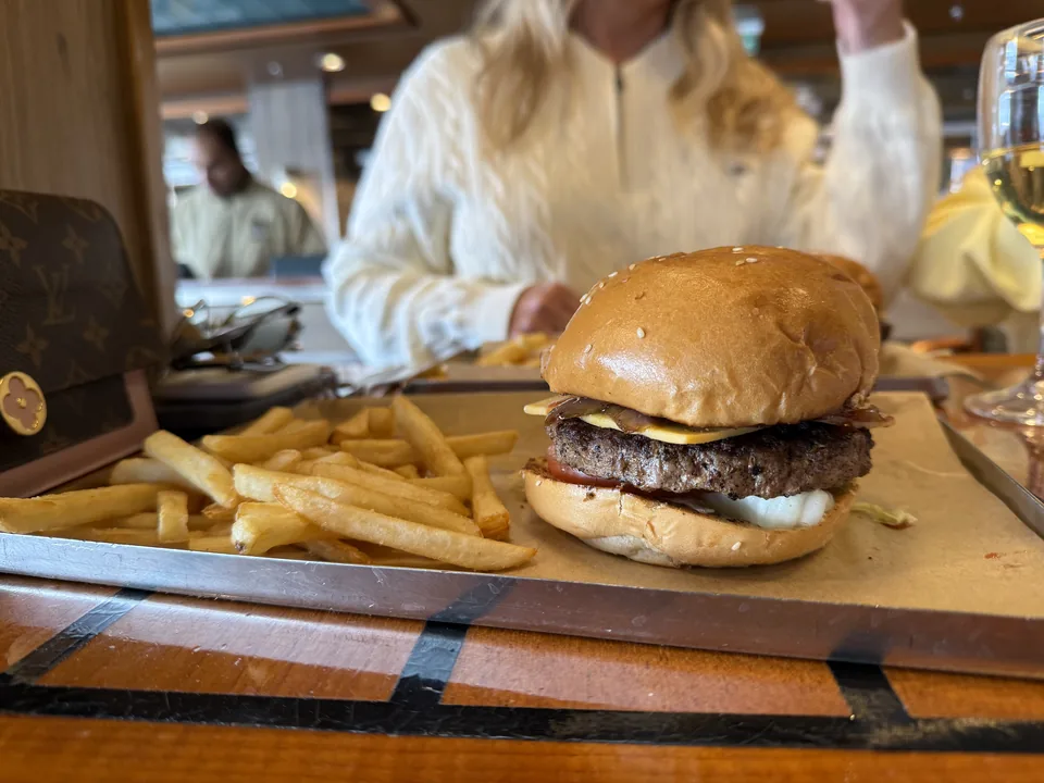 Cheeseburger med pommes frites på metalbakke til frokost på American Diner på Norwegian Escape
