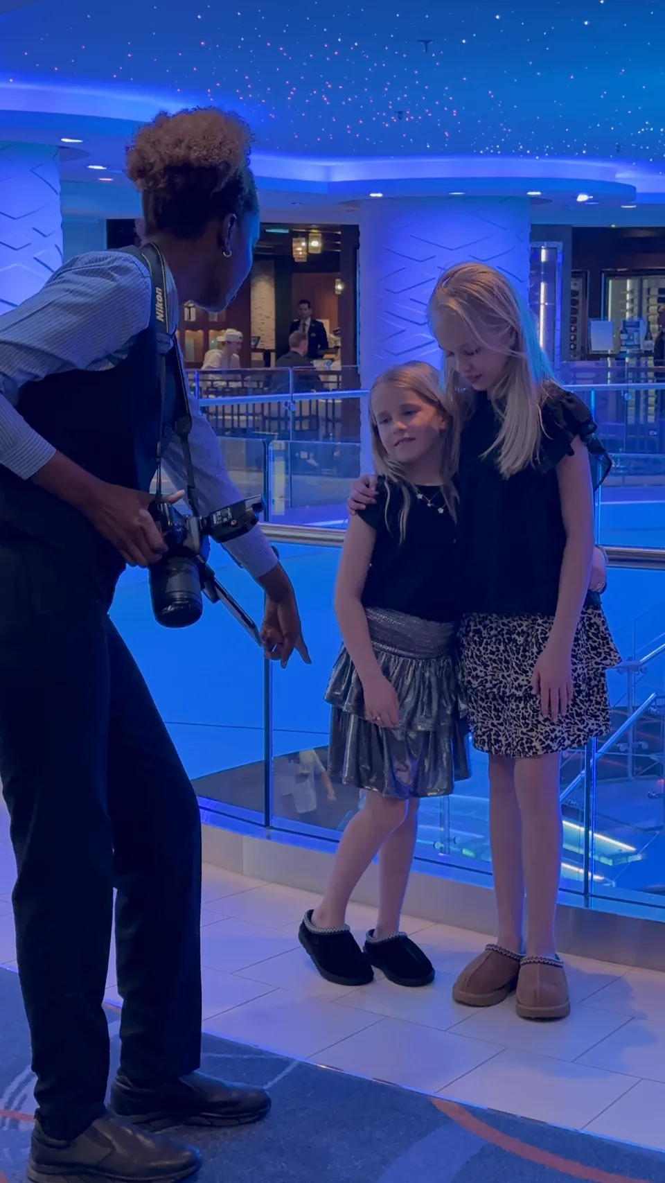Skibets fotograf tager portrætter af to piger under det blå stjerneloft på Norwegian Escape