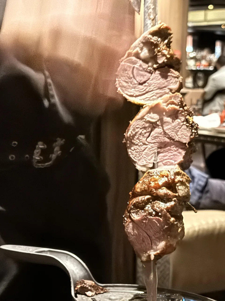 Nærbillede af grillet kød på spyd serveret ved bordet på Moderno Churrascaria på Norwegian Escape
