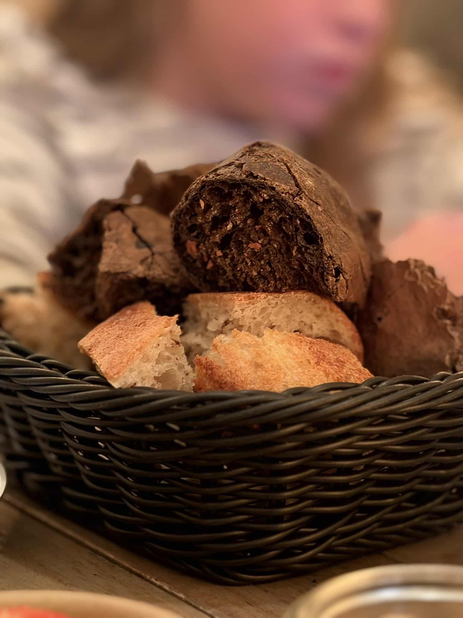 Brødkurv med stykker af mørkt og lyst brød